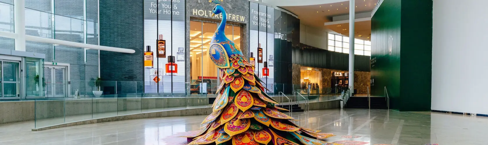 Peacock installation in colourful feathers.