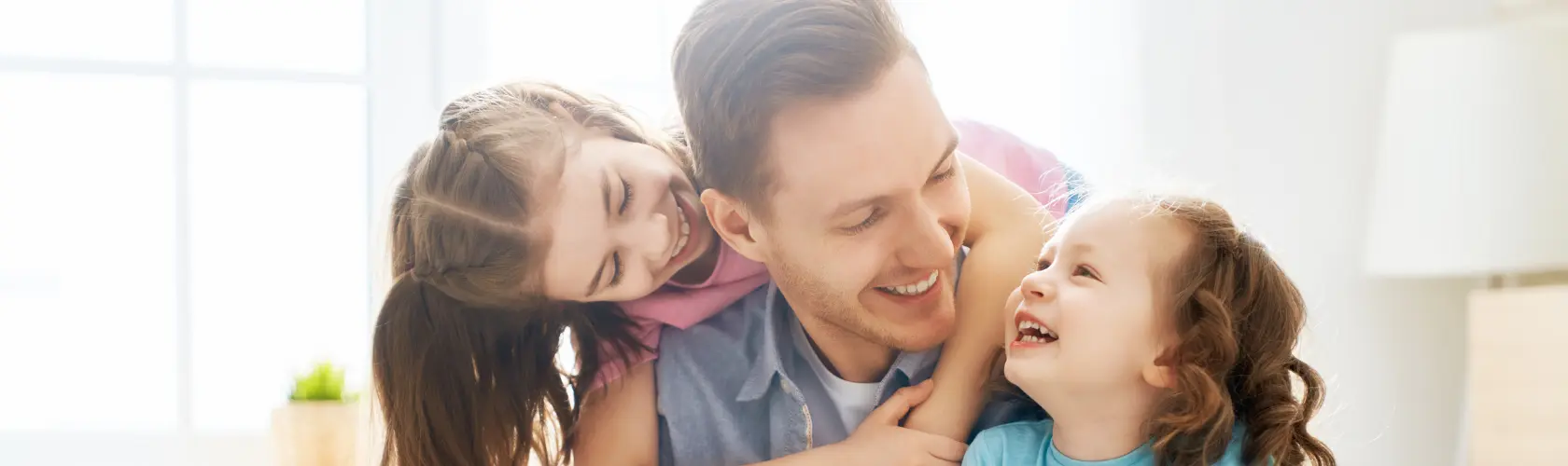 A father with his two daughters