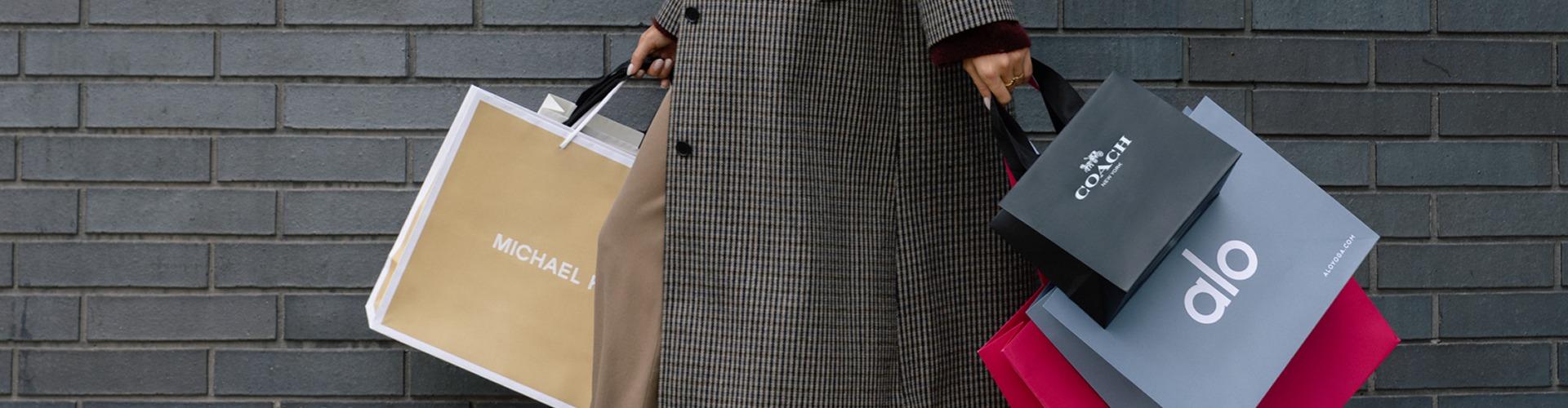 Shopper carrying multiple bags, showcasing exclusive deals and retail variety at the shopping centre