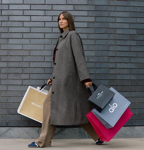 Shopper carrying multiple bags, showcasing exclusive deals and retail variety at the shopping centre
