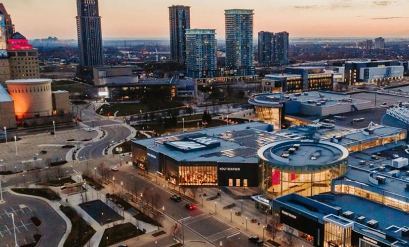 Shopping centre exterior with surrounding cityscape, road networks, and urban infrastructure