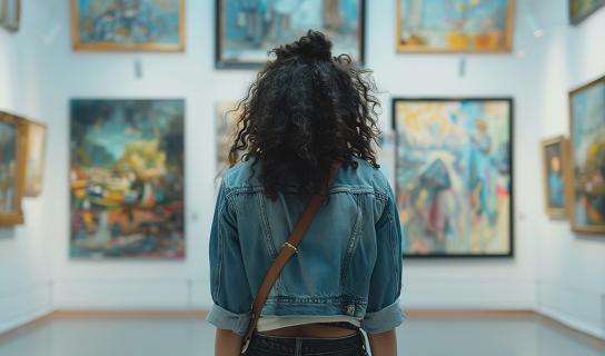 Visitor viewing contemporary artwork inside a modern art gallery with curated exhibits