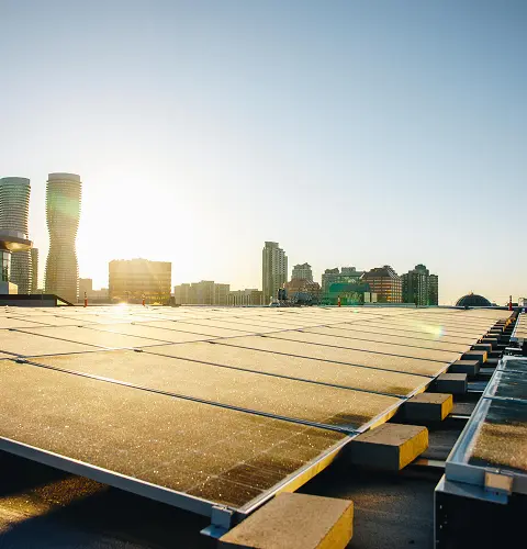 Solar panels installed on the rooftop generating clean energy with a skyline backdrop