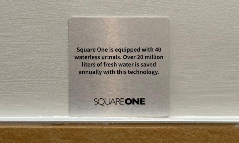 Water conservation signage highlighting waterless systems and efficient resource usage initiatives